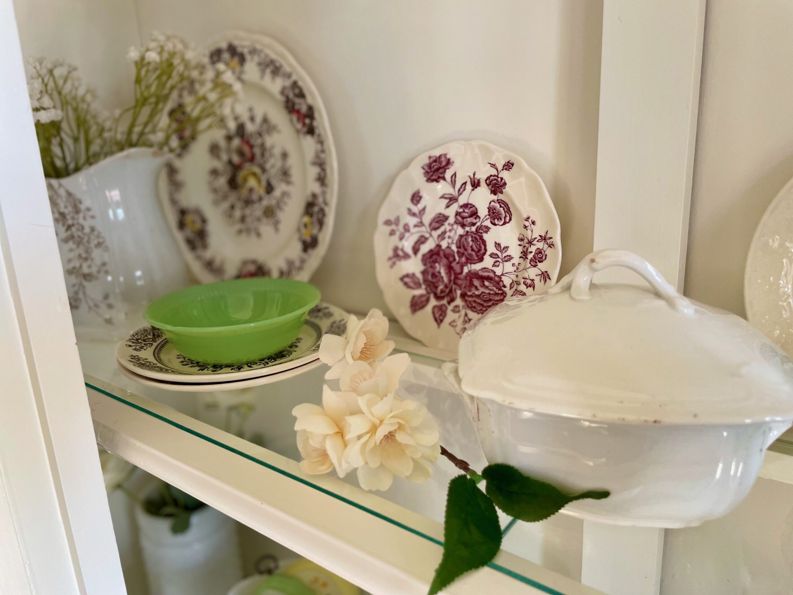 vintage decor in a white hutch for Spring
