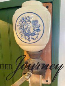 a ceramic blue and white vintage coffee grinder 