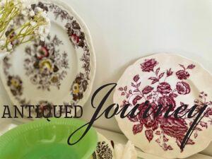 vintage transferware plates and vintage jadeite displayed in a white hutch for Spring