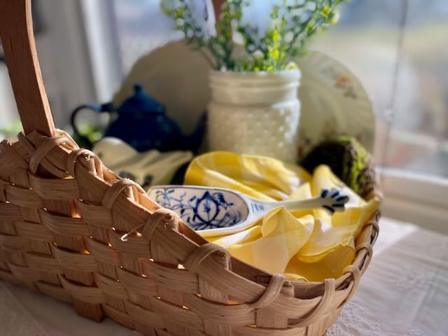 a thrifted basket used to create a Spring basket vignette
