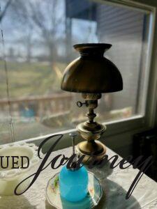 a vintage brass lamp sitting on a credenza