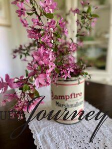 pink Crabapple stems in a vintage marshmallow tin