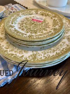 a stack of vintage thrifted green transferware plates 