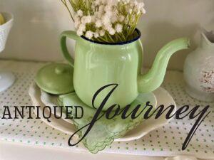a vintage green Swedish hanky styled underneath a enamel teapot with Ironstone