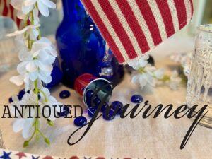 blue stones with mini patriotic pails for a 4th of July centerpiece