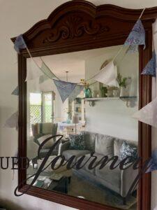 a DIY patriotic bunting banner draped over a mirror