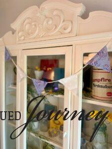 a DIY Patriotic bunting banner displayed on a hutch