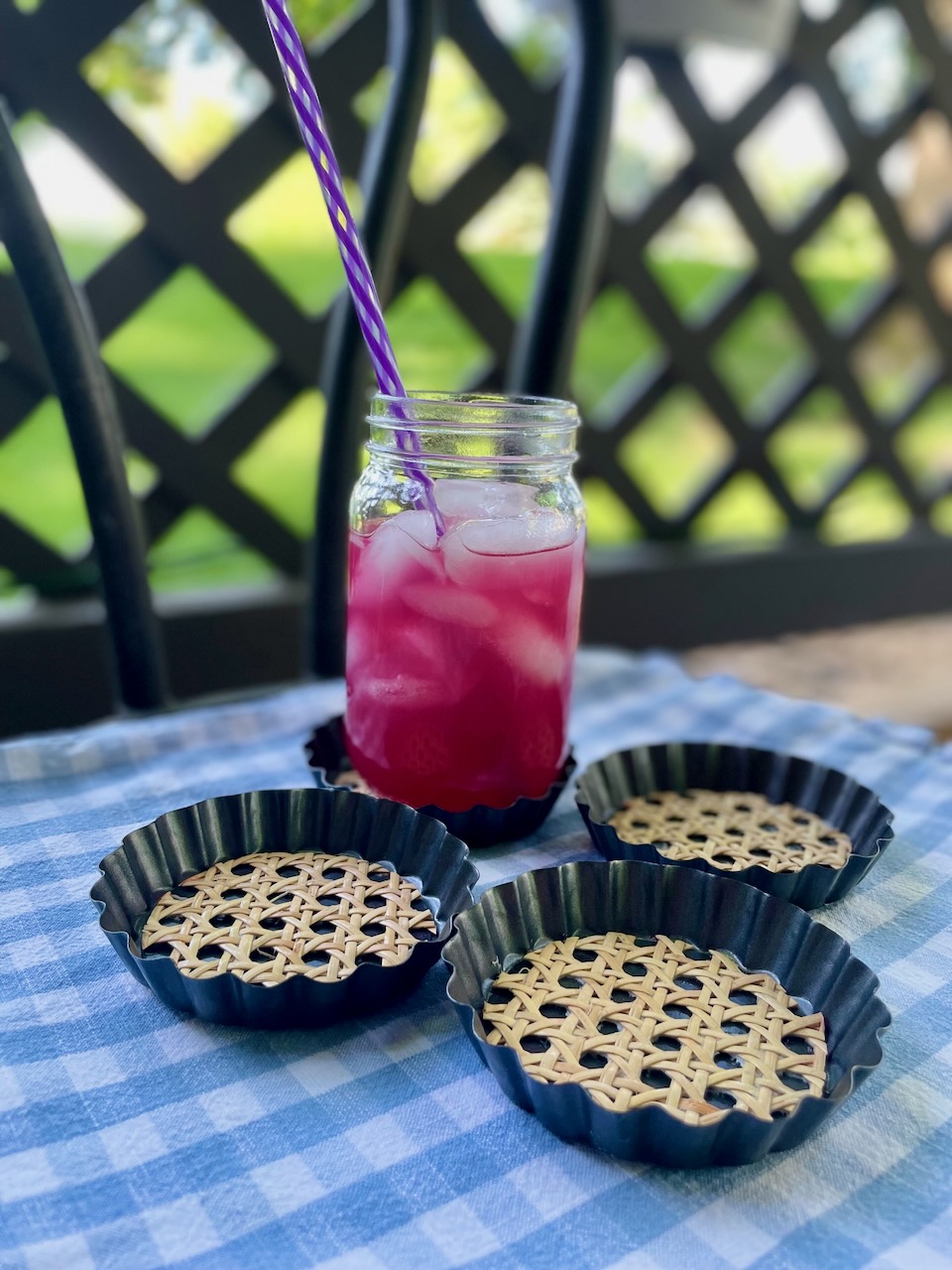 DIY mini tart pan coasters with cane on a patio