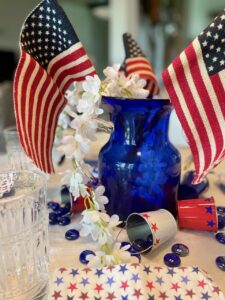 a 4th of July centerpiece with flags and thrifted items