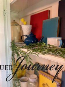 vintage enamelware and books styled into a hutch for Summer