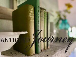 vintage books and vintage milk glass styled on a shelf for Summer