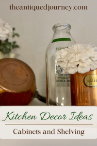 vintage decor styled on the tops of kitchen cabinets