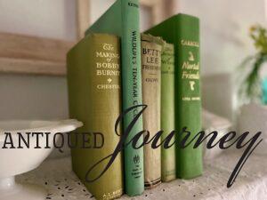 vintage green books styled on a shelf with vintage milk glass