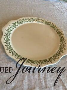a vintage green and white handled plate