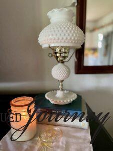 a vintage milk glass lamp styled on some books
