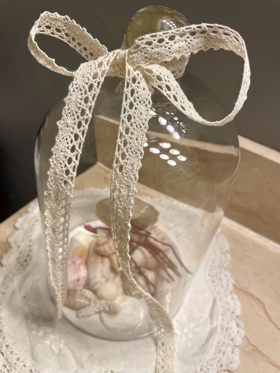 a DIY seashell cloche with lace ribbon