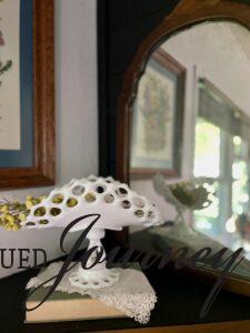 a vintage lace hanky styled on a mantel with milk glass