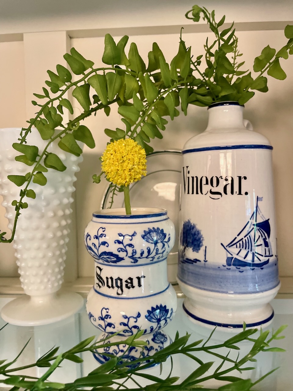 thrifted blue and white jars styled with greenery