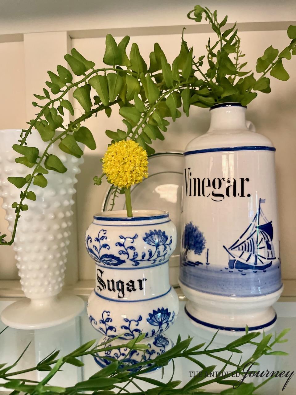 thrifted blue and white jars styled with greenery