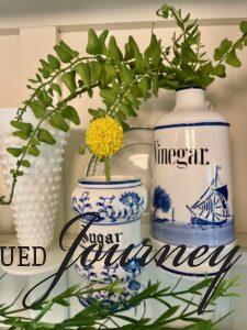 blue and white vintage kitchen vessels displayed with faux greenery