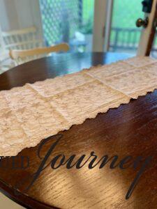a vintage linen table runner used for sunflower tablescape