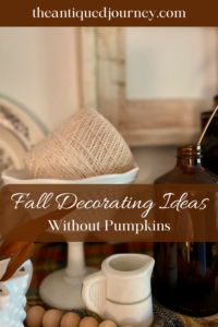a vintage Fall vignette with amber bottles and milk glass