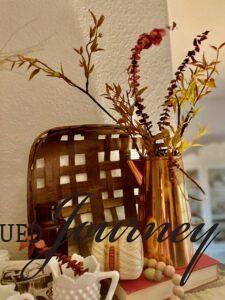 a vintage copper pot used in a Fall vignette with faux leaves