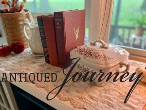 a Fall vignette styled with antique brown transferware and vintage books