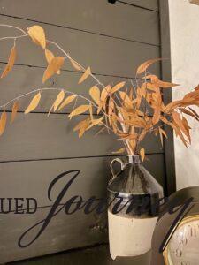 gold eucalyptus stems in a vintage crock for Fall
