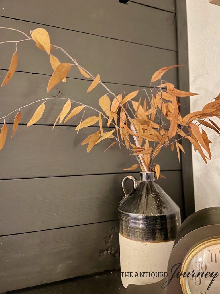gold eucalyptus stems in a vintage crock for Fall
