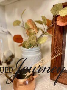 Fall hutch decor with vintage items and faux leaf stems