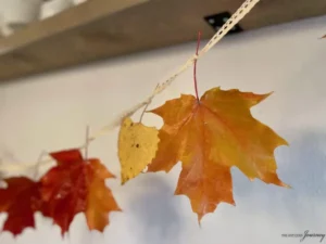 a DIY Fall Waxed Leaf Garland with ribbon