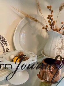 a vintage ironstone platter used in the background of a hutch for Fall