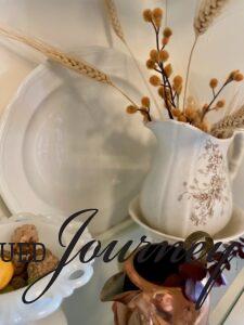 an antique ironstone pitcher filled with faux wheat and other vintage decor for a Fall hutch