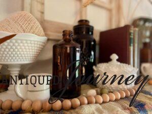 a vintage Fall vignette with Amber colored bottles, milk glass and vintage thread spools