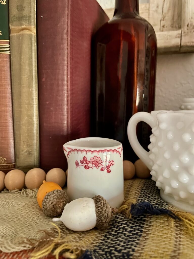 a vintage cafe creamer with red florals