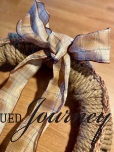 a plaid bow on a DIY rope wreath for Fall