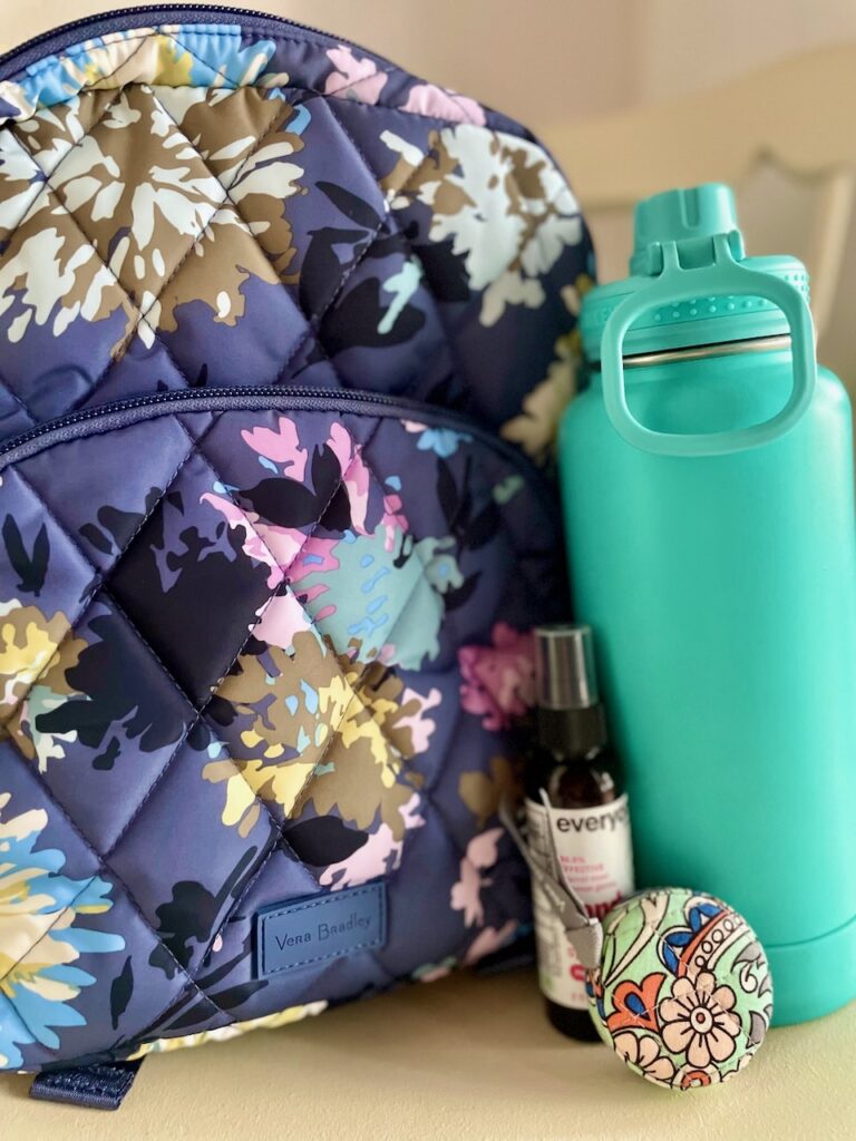 thrifting essentials including a backpack and water bottle