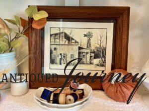 vintage barn artwork displayed in a hutch for Fall