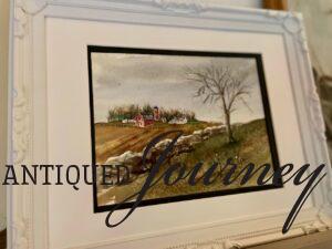 a vintage watercolor painting with a barn and fields styled for Fall