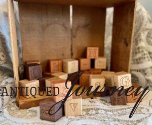 wooden alphabet blocks in a wooden crate