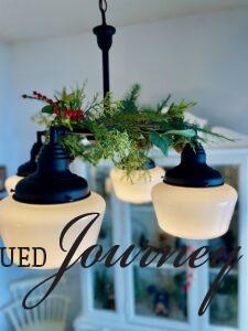 faux garland on a chandelier for Christmas decor