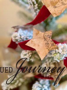 a gold dry brushed star on a DIY Christmas garland with vintage sheet music