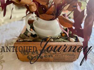 a thrifted Thanksgiving centerpiece with a vintage wooden crate