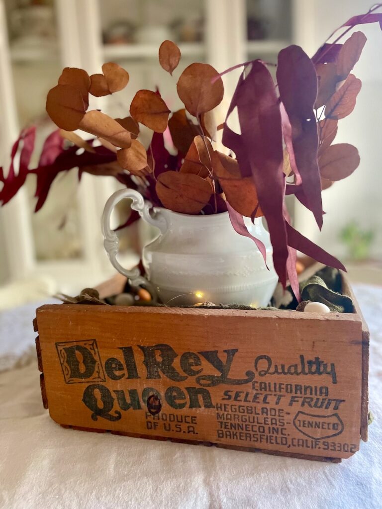 a thanksgiving centerpiece with a thrifted wooden crate