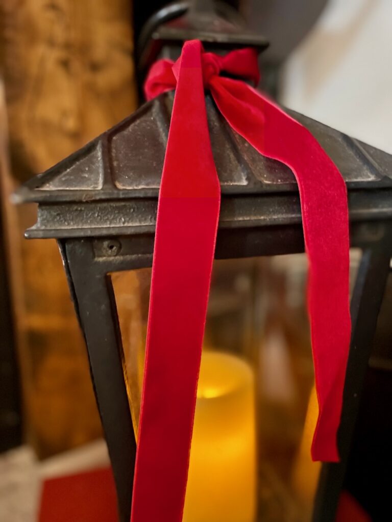 red velvet ribbon tied onto a black lantern