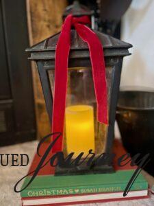 a lantern tied with ribbon on a hearth