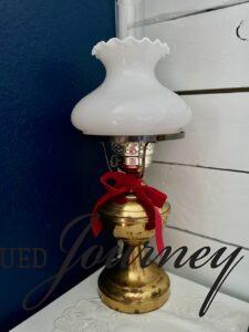 vintage brass and milk glass lamp with red velvet ribbon