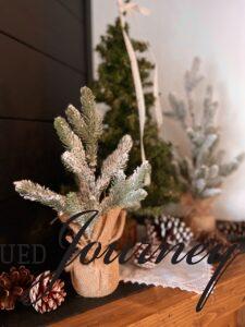 Winter mantel decor with flocked trees