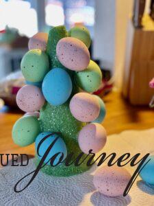 gluing eggs on Easter topiary